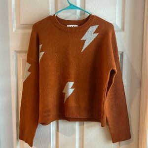 Orange sweater with white lightning bolts. Size small. Like New. THML brand